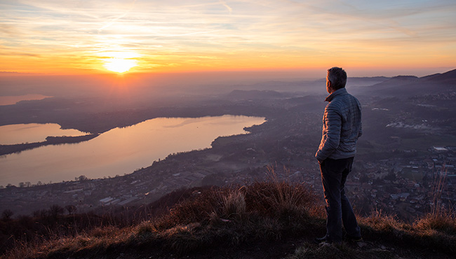 Hiker looking at the sun set over the horizon